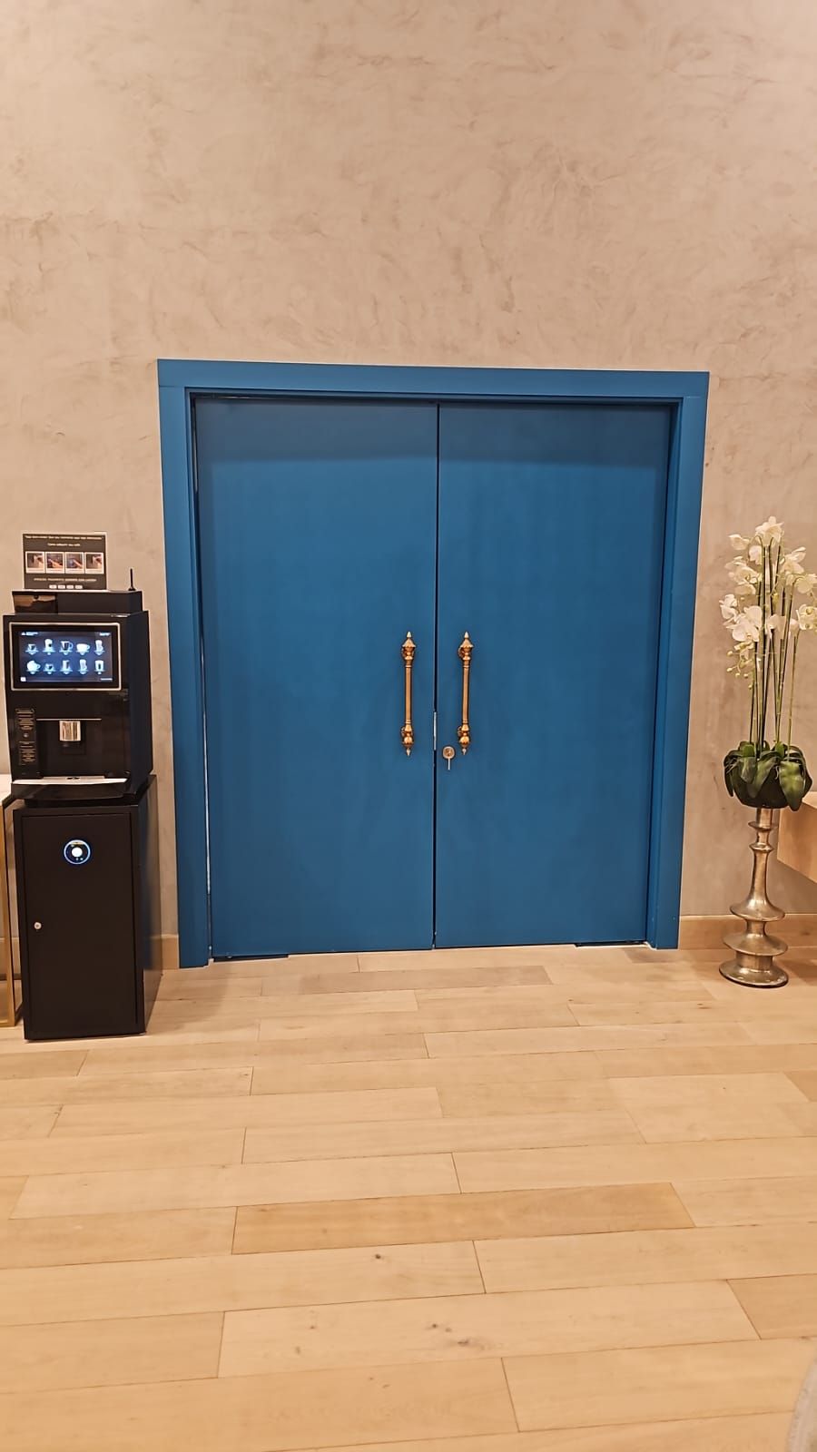 Blue Lacquered Double Doors With Brass Pulls In Lobby