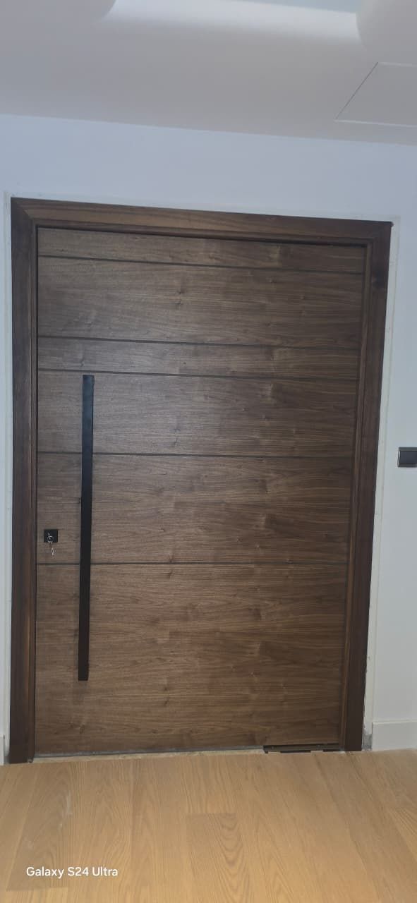 Walnut pivot door seen from inside the hall, Jumeirah