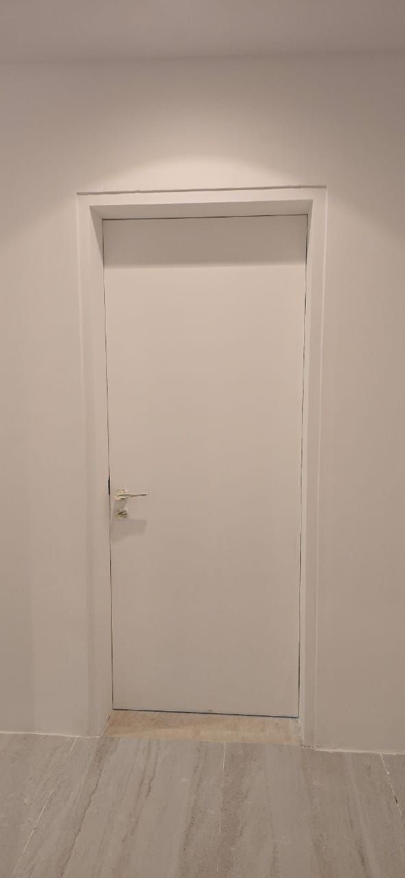 Hidden door in a white hallway