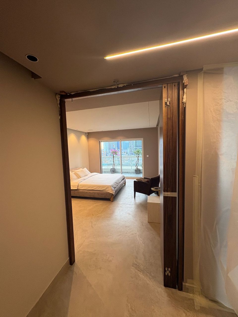 Tall Timber Door Opening Into Bedroom