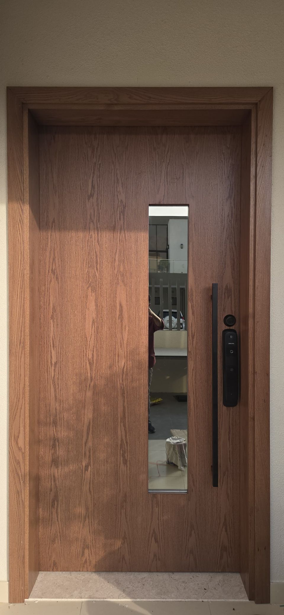 Walnut main door with a glazed vision slot